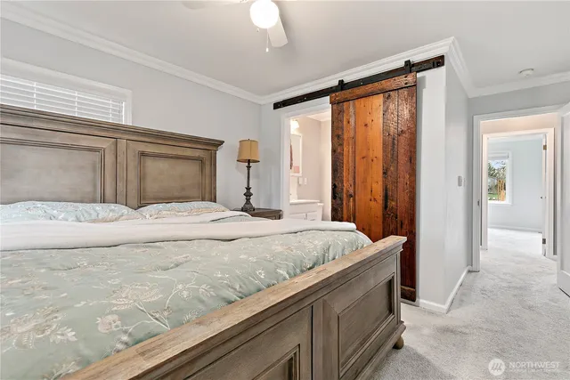 a bedroom with a large bed and a window