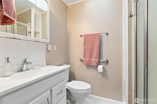 a bathroom with a sink toilet and a mirror