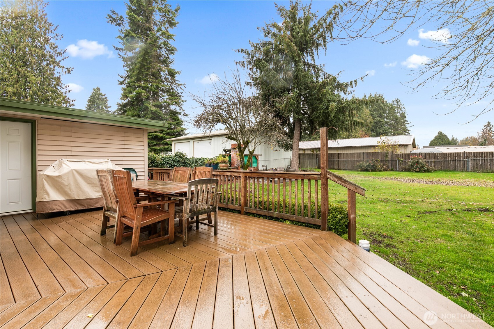 111 East Cindy Road Centralia, WA 98531 - Photo 16 of 17 a view of a roof deck with table and chairs with wooden floor and fence