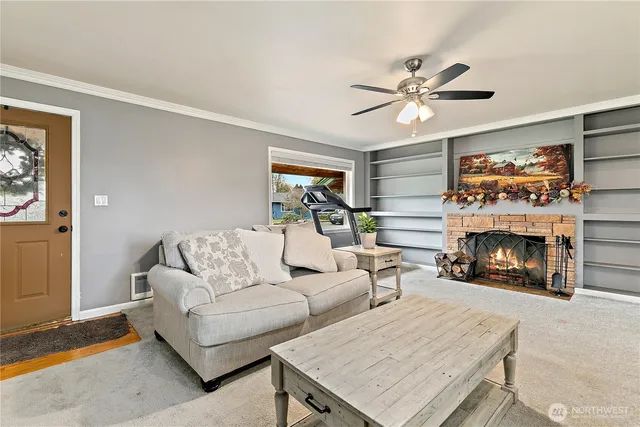 a living room with furniture and a fireplace