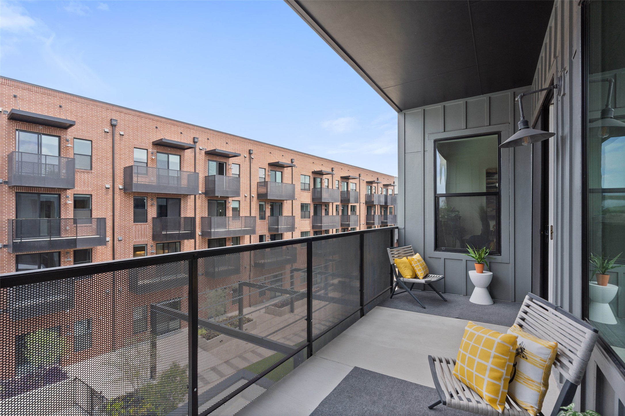 4510 Terry-O Lane, Unit 341 Austin, TX 78745 - Photo 38 of 40 The property features a private balcony with concrete flooring and a dark grey privacy screen
