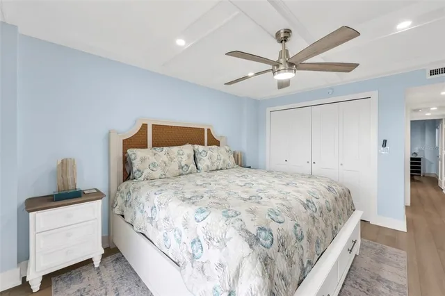 a bedroom with a bed and a ceiling fan