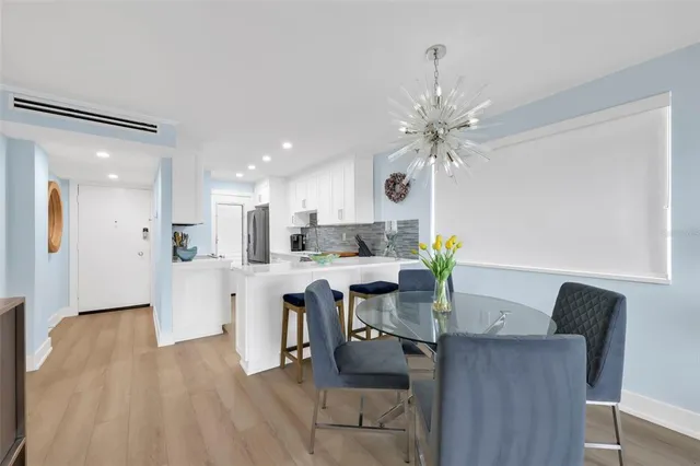 a view of a dining room with furniture and a chandelier