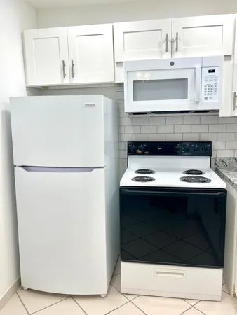 a stove top oven sitting inside of a kitchen