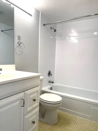 a bathroom with a toilet sink and shower