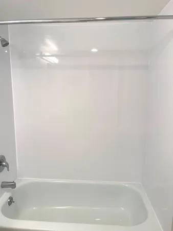 a bathroom with a shower and a bath tub