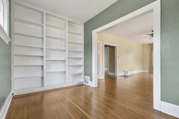 a view of a room with wooden floor and closet