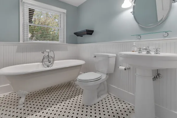 a bathroom with a sink a toilet and a mirror