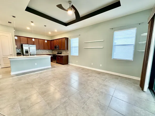 a view of kitchen with refrigerator and window