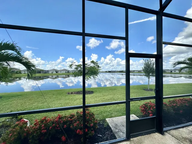 a view of a balcony with chair and floor to ceiling window