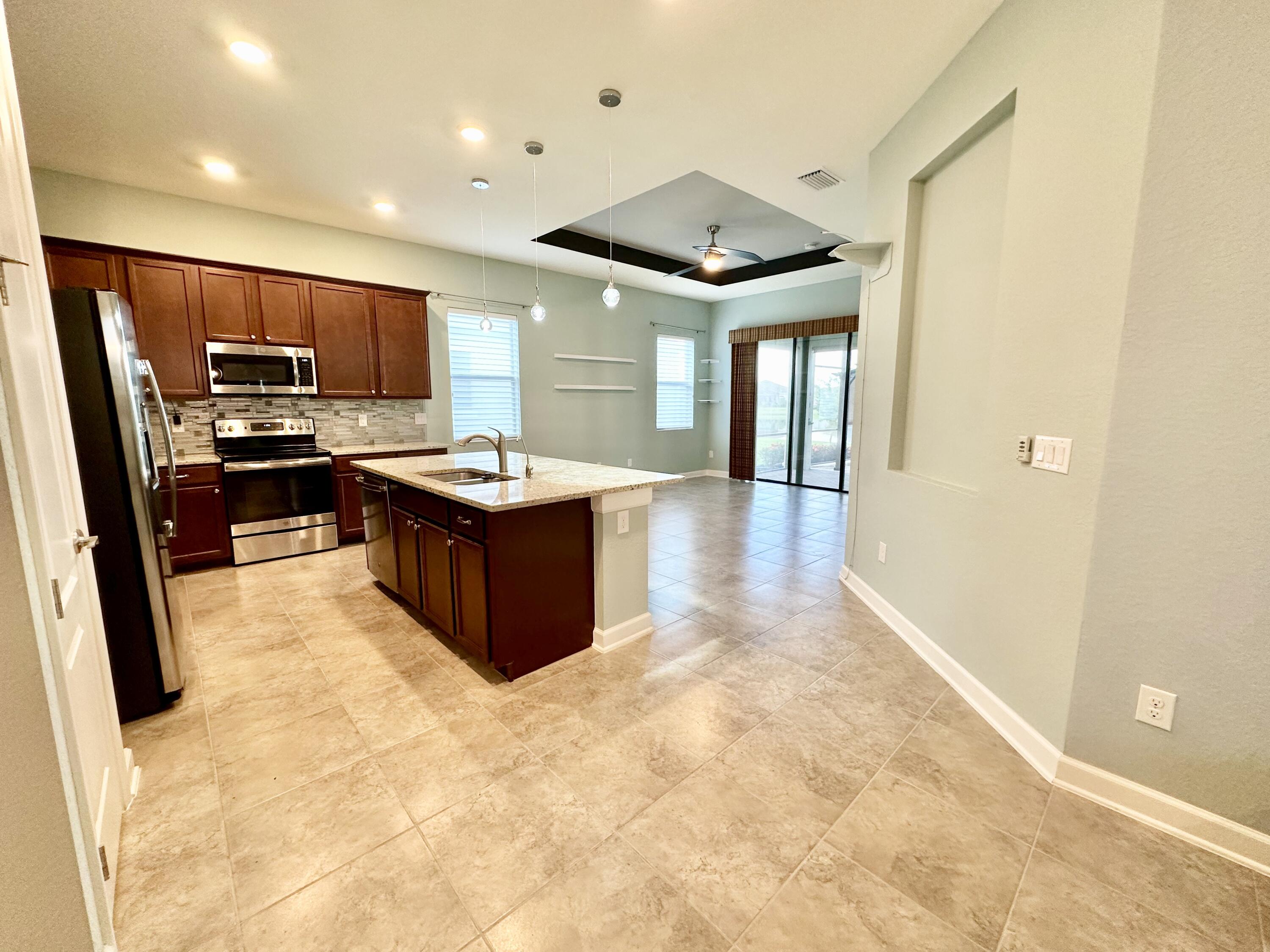 2491 Treasure Cay Lane Melbourne, FL 32940 - Photo 2 of 15 a kitchen with kitchen island a sink stainless steel appliances and cabinets