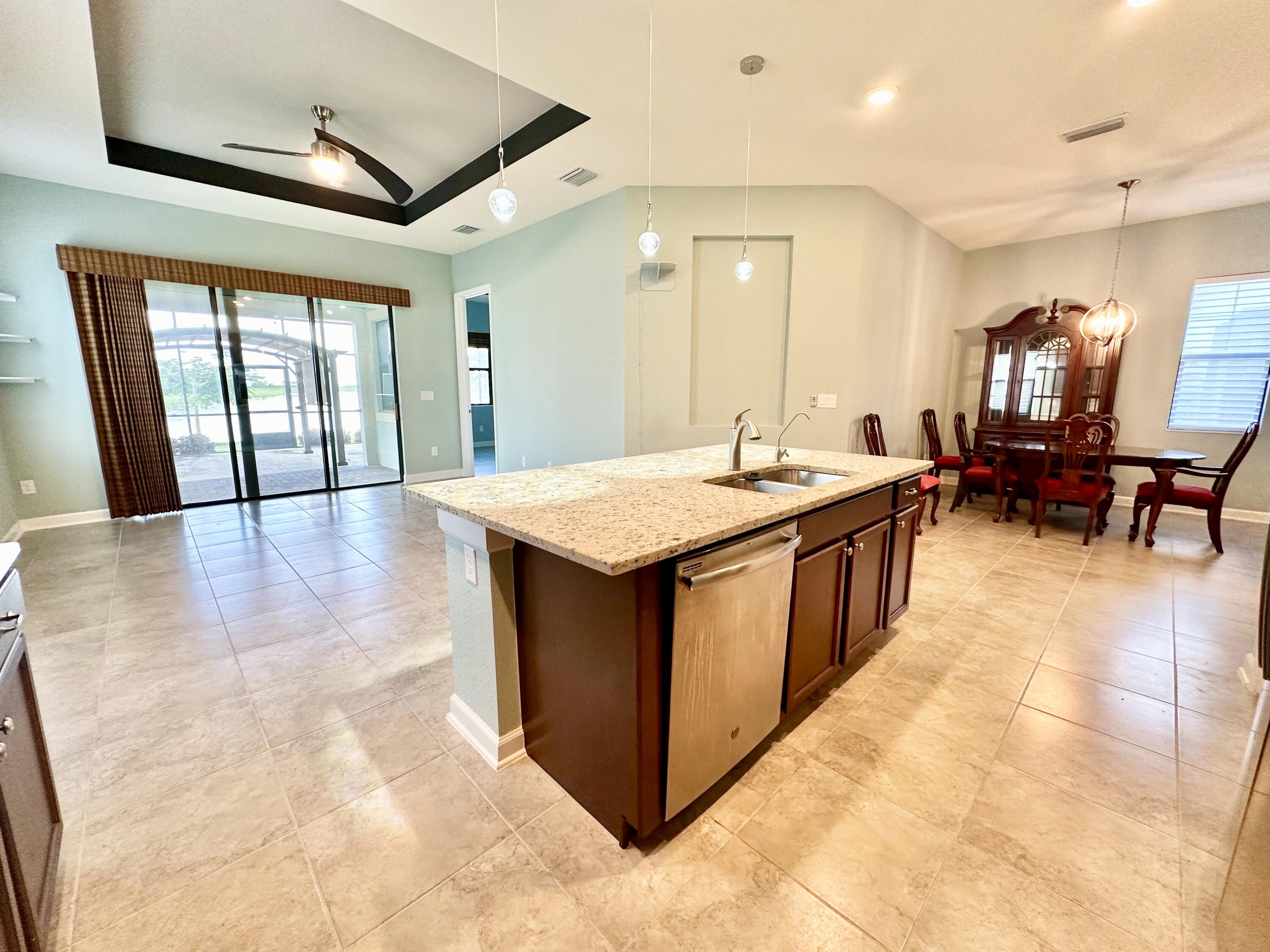 2491 Treasure Cay Lane Melbourne, FL 32940 - Photo 8 of 15 a dining hall with stainless steel appliances granite countertop a sink and a refrigerator