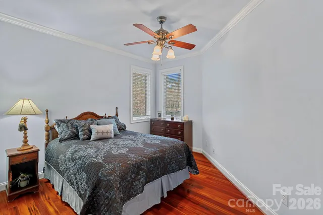 a living room with furniture a flat screen tv and kitchen view