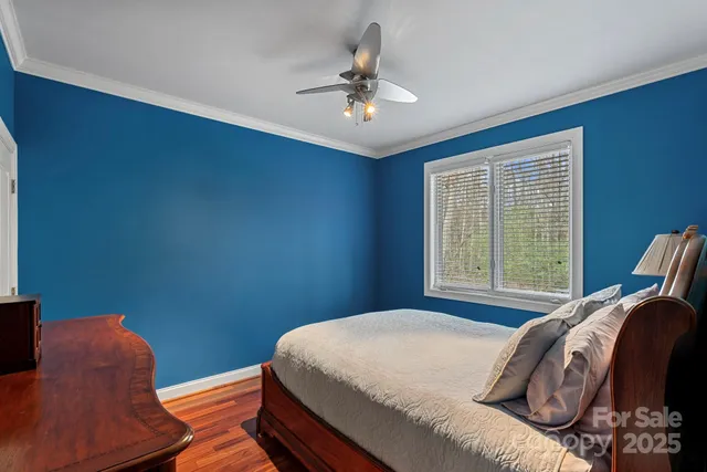 a bedroom with two beds and a chandelier
