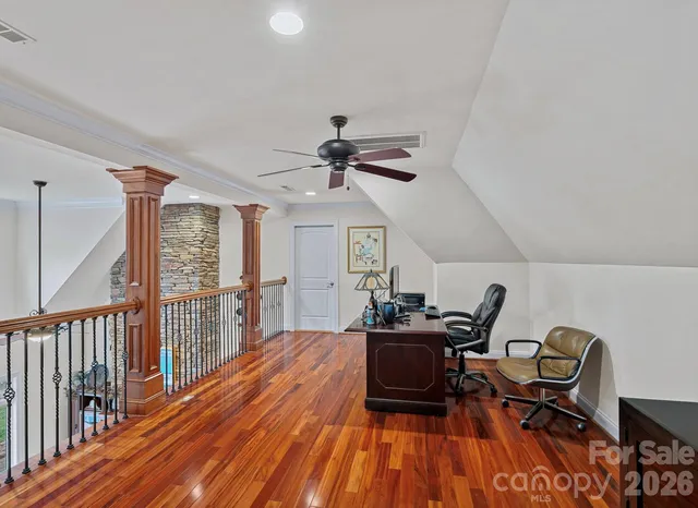 a pathway of a house with yard and trees in the background