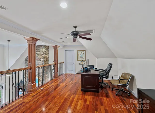 a pathway of a house with yard and trees in the background