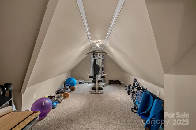 a view of a house with a big yard and large trees