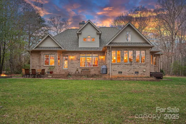 a view of backyard with swimming pool and outdoor seating