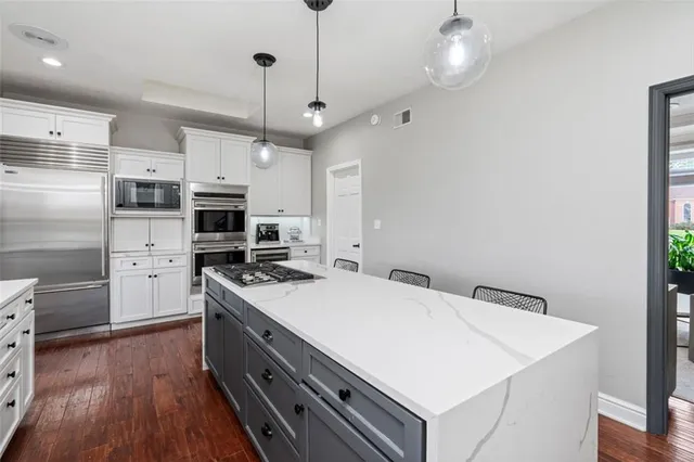 a kitchen with stainless steel appliances a stove a sink and a refrigerator