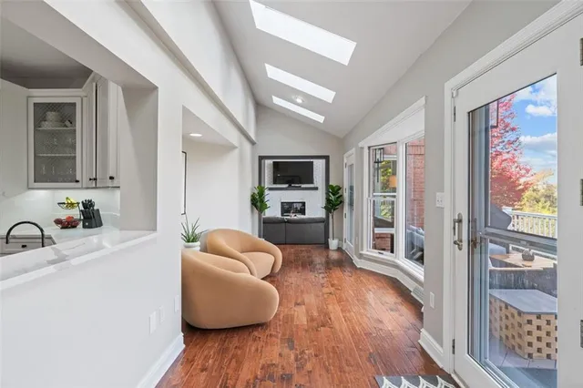 a living room with furniture wooden floor and a flat screen tv