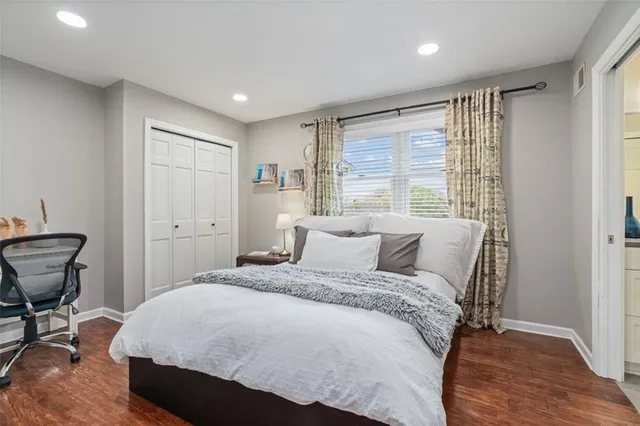 a bedroom with a bed and a window