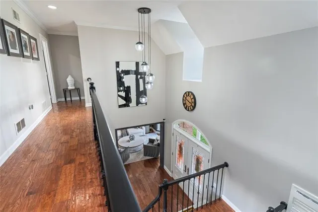 a view of a livingroom with furniture hardwood floor and staircase