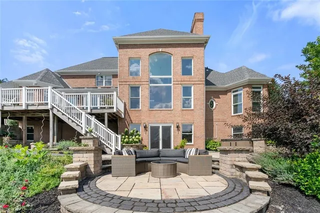 a view of a brick house with a fountain plants and a fountain