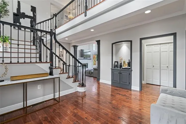 a view of entryway and hall with wooden floor