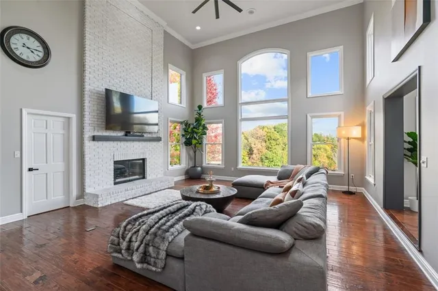a living room with furniture fireplace and flat screen tv