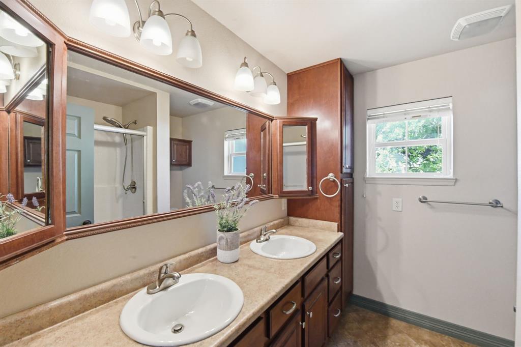 505 Highland Oak Point, TX 75068 - Photo 13 of 38 a bathroom with a granite countertop sink and a mirror