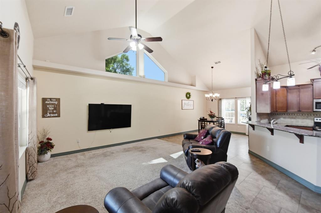 505 Highland Oak Point, TX 75068 - Photo 15 of 38 a living room with furniture kitchen view and a flat screen tv