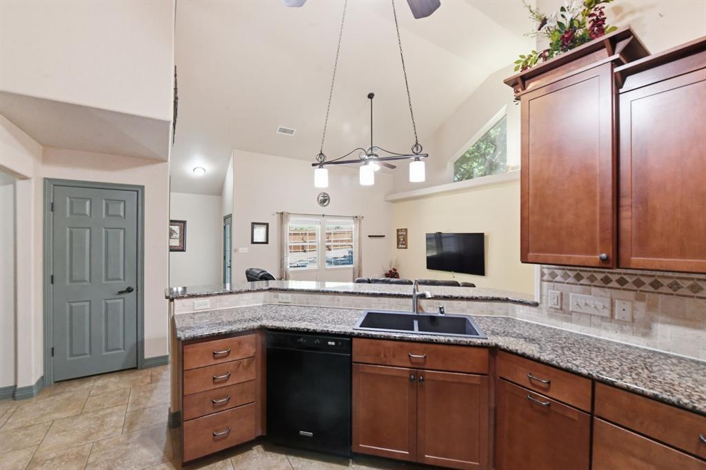 505 Highland Oak Point, TX 75068 - Photo 18 of 38 a kitchen with a sink stove and refrigerator