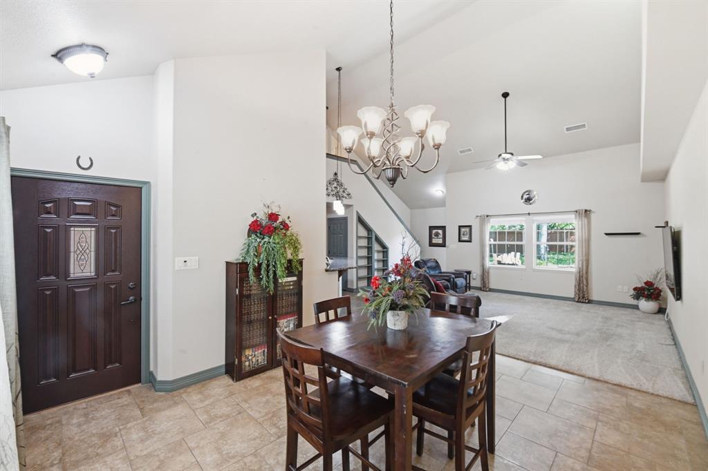 505 Highland Oak Point, TX 75068 - Photo 21 of 38 a view of a dining room with furniture and chandelier