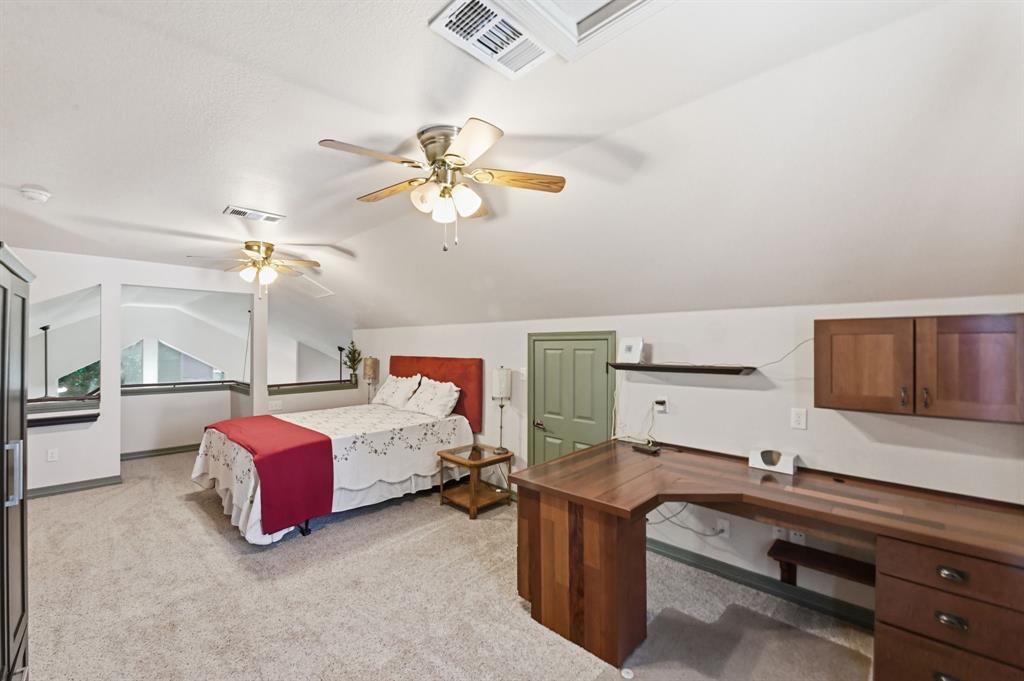 505 Highland Oak Point, TX 75068 - Photo 24 of 38 a bedroom with a bed and ceiling fan