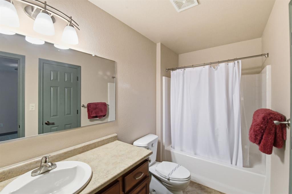 505 Highland Oak Point, TX 75068 - Photo 27 of 38 a bathroom with a sink a toilet and shower curtain