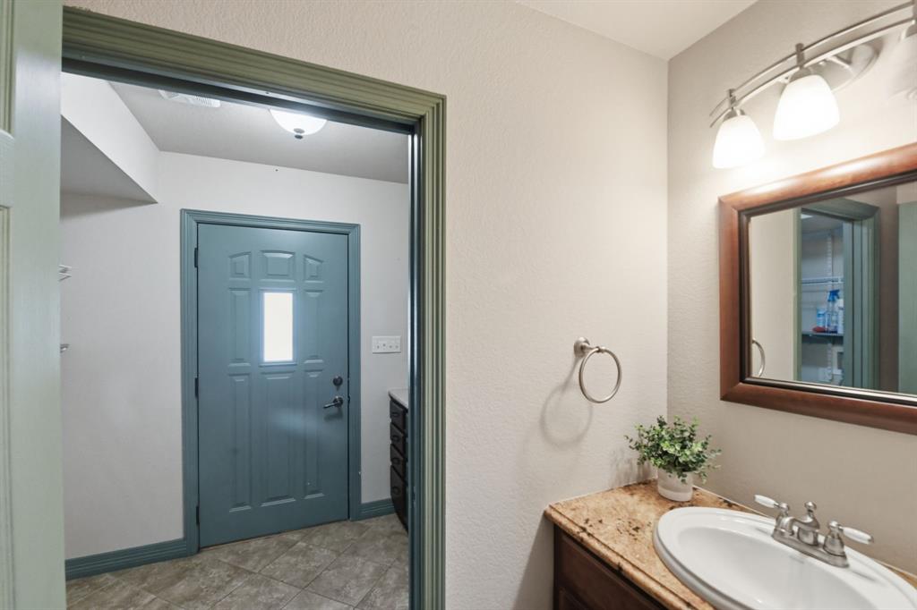 505 Highland Oak Point, TX 75068 - Photo 29 of 38 a bathroom with a granite countertop sink a toilet and mirror