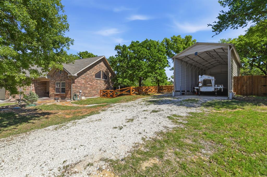 505 Highland Oak Point, TX 75068 - Photo 5 of 38 a view of a house with a patio and a yard