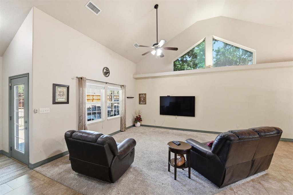 505 Highland Oak Point, TX 75068 - Photo 9 of 38 a living room with furniture and a flat screen tv