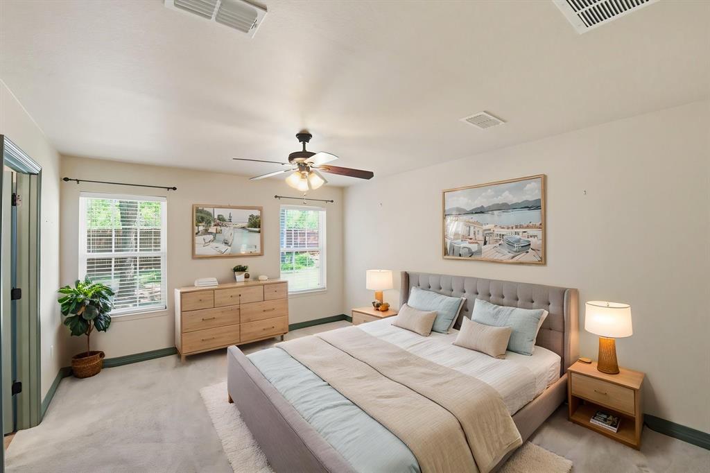 505 Highland Oak Point, TX 75068 - Photo 10 of 38 a bedroom with a bed and a chandelier