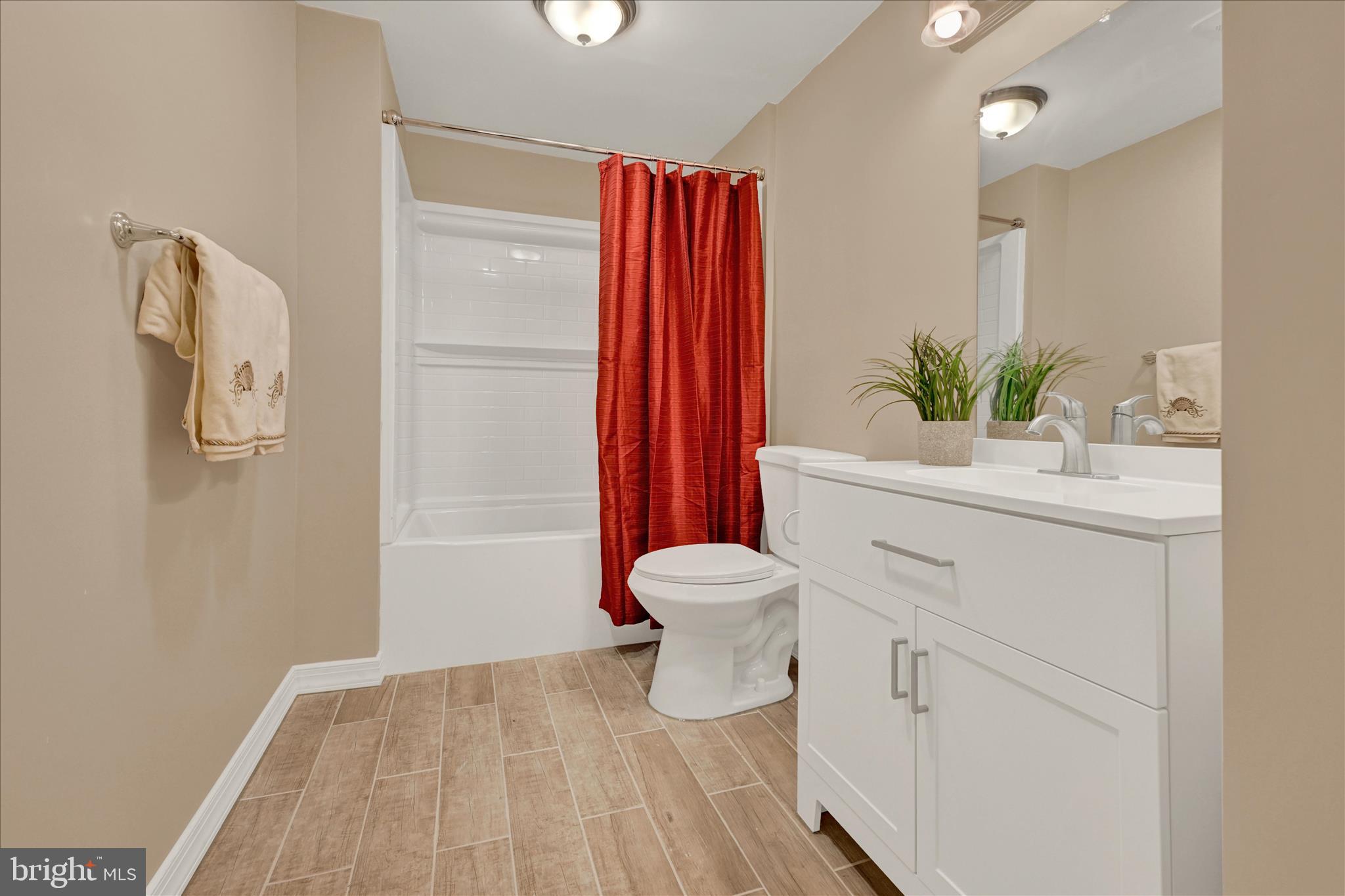 8511 Frederick Road Ellicott City, MD 21043 - Photo 28 of 36 a bathroom with a sink toilet and shower