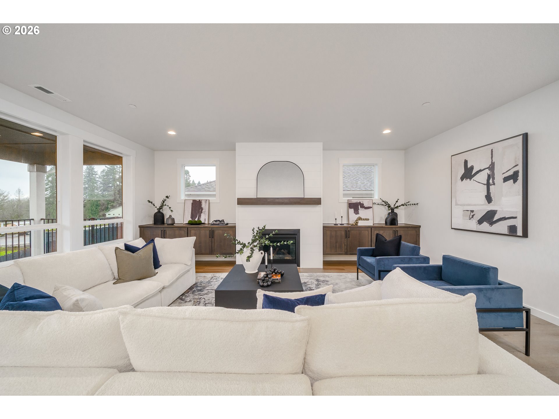 516 West 20th Way La Center, WA 98629 - Photo 18 of 45 a living room with furniture a fireplace and a large window