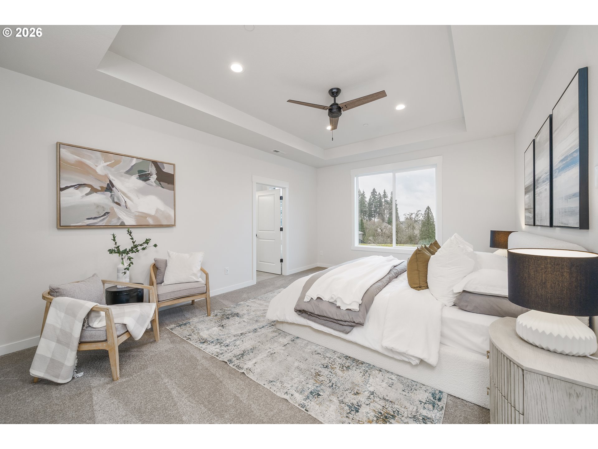 516 West 20th Way La Center, WA 98629 - Photo 30 of 45 a bedroom with a bed a couch and a chandelier