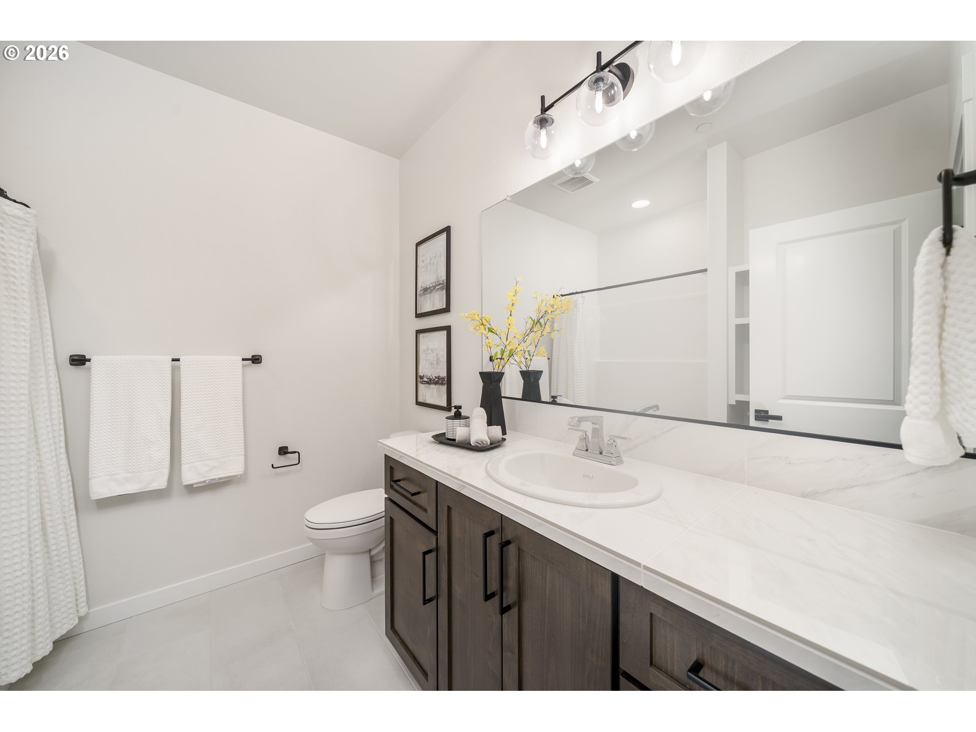 516 West 20th Way La Center, WA 98629 - Photo 10 of 45 a bathroom with a sink toilet a mirror and shower