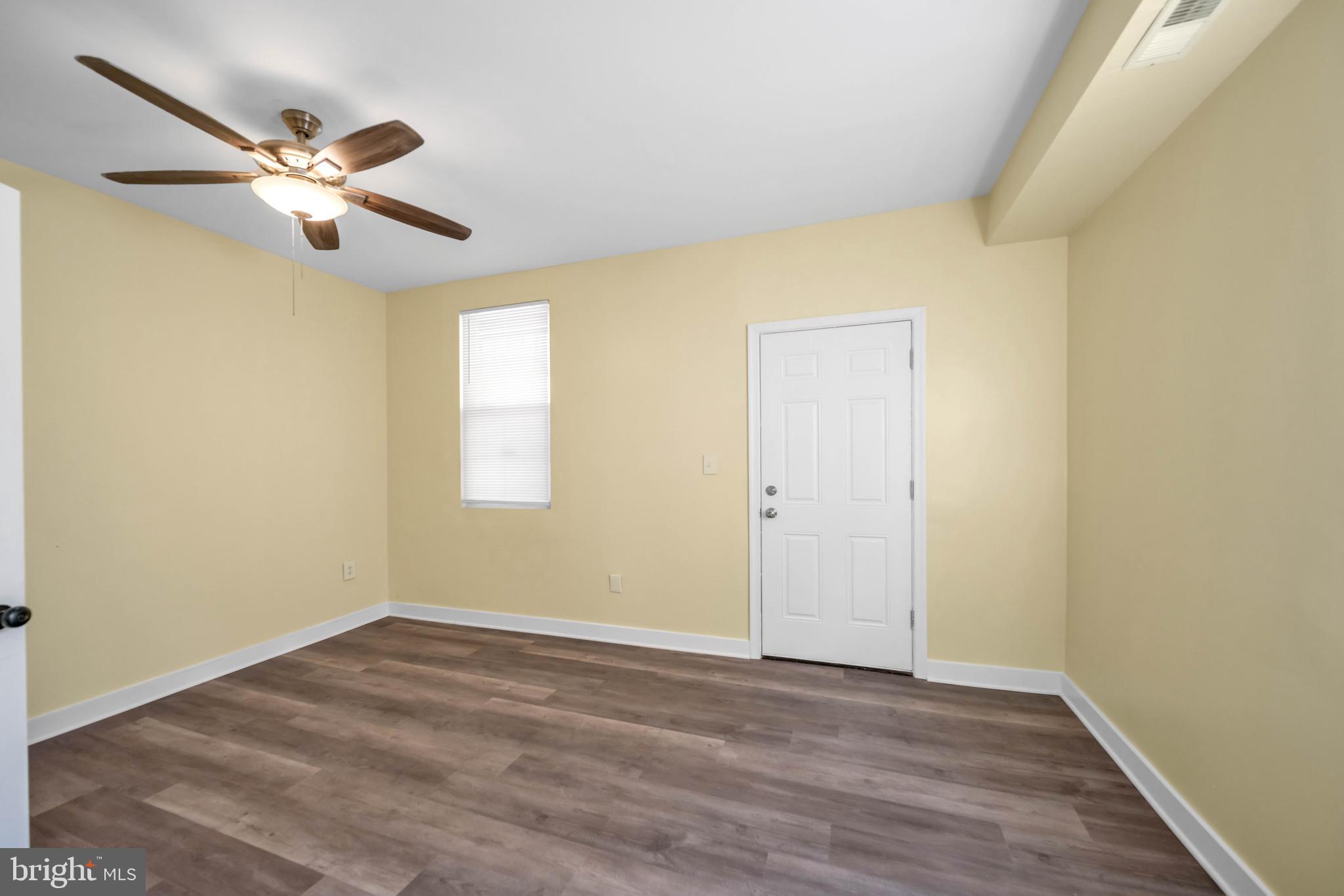 2712 Sherman Avenue Northwest Washington, DC 20001 - Photo 11 of 69 a view of a room with wooden floor closet and a ceiling fan