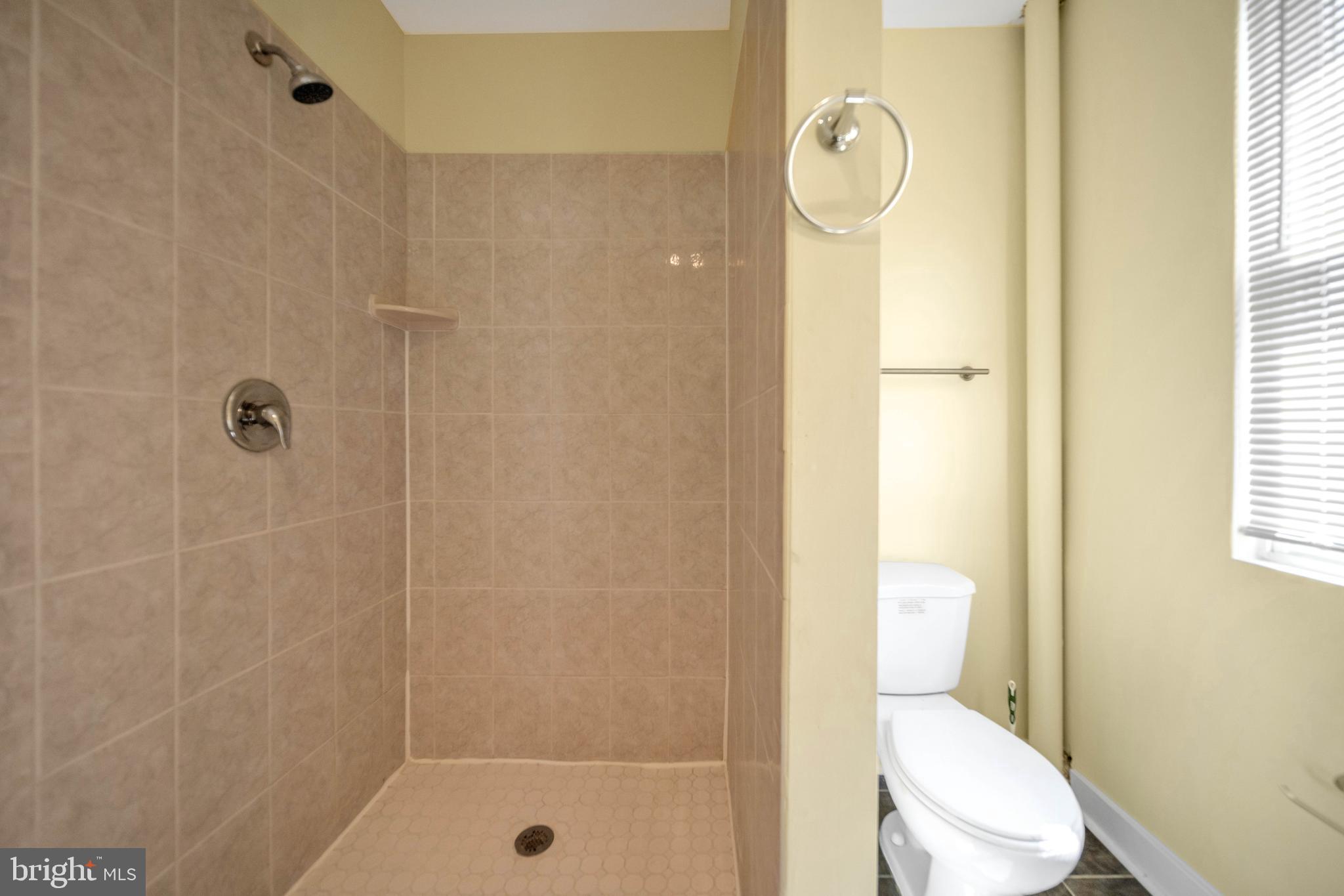 2712 Sherman Avenue Northwest Washington, DC 20001 - Photo 17 of 69 a white toilet sitting next to a bathroom sink