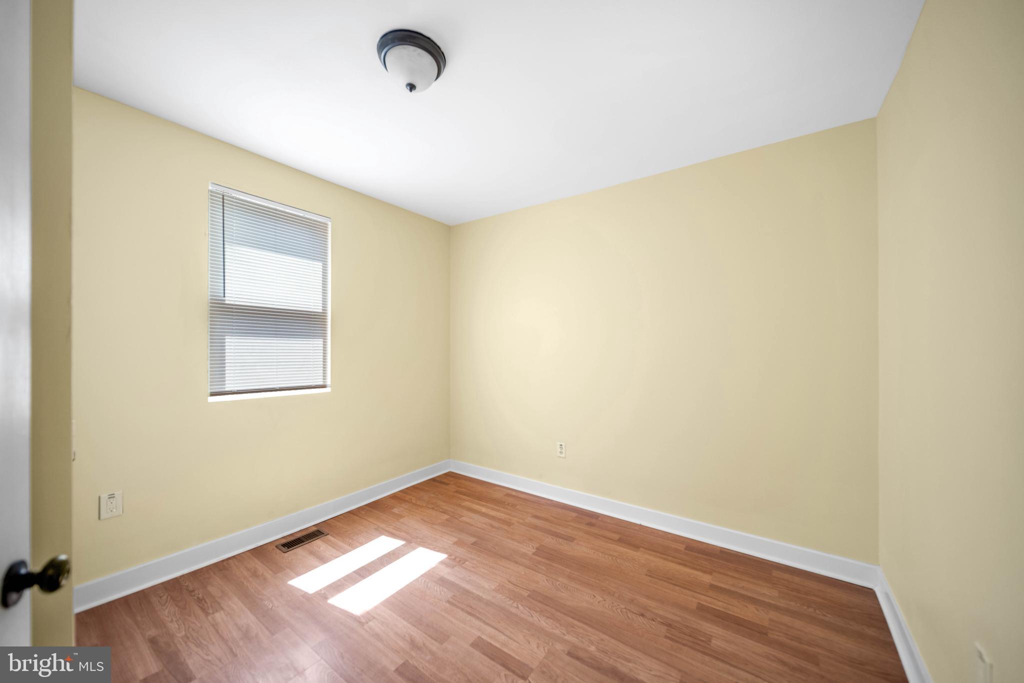 2712 Sherman Avenue Northwest Washington, DC 20001 - Photo 19 of 69 an empty room with wooden floor and windows