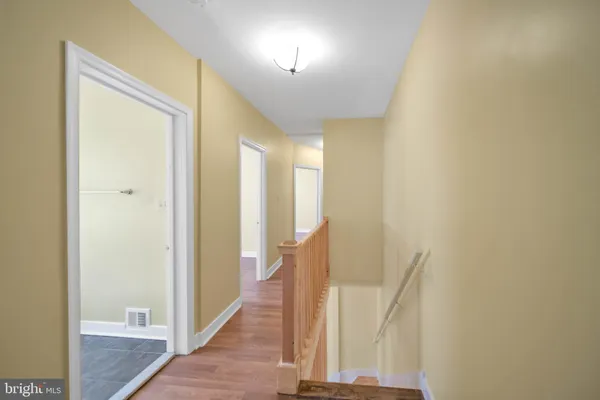 a view of a room with wooden floor and a window