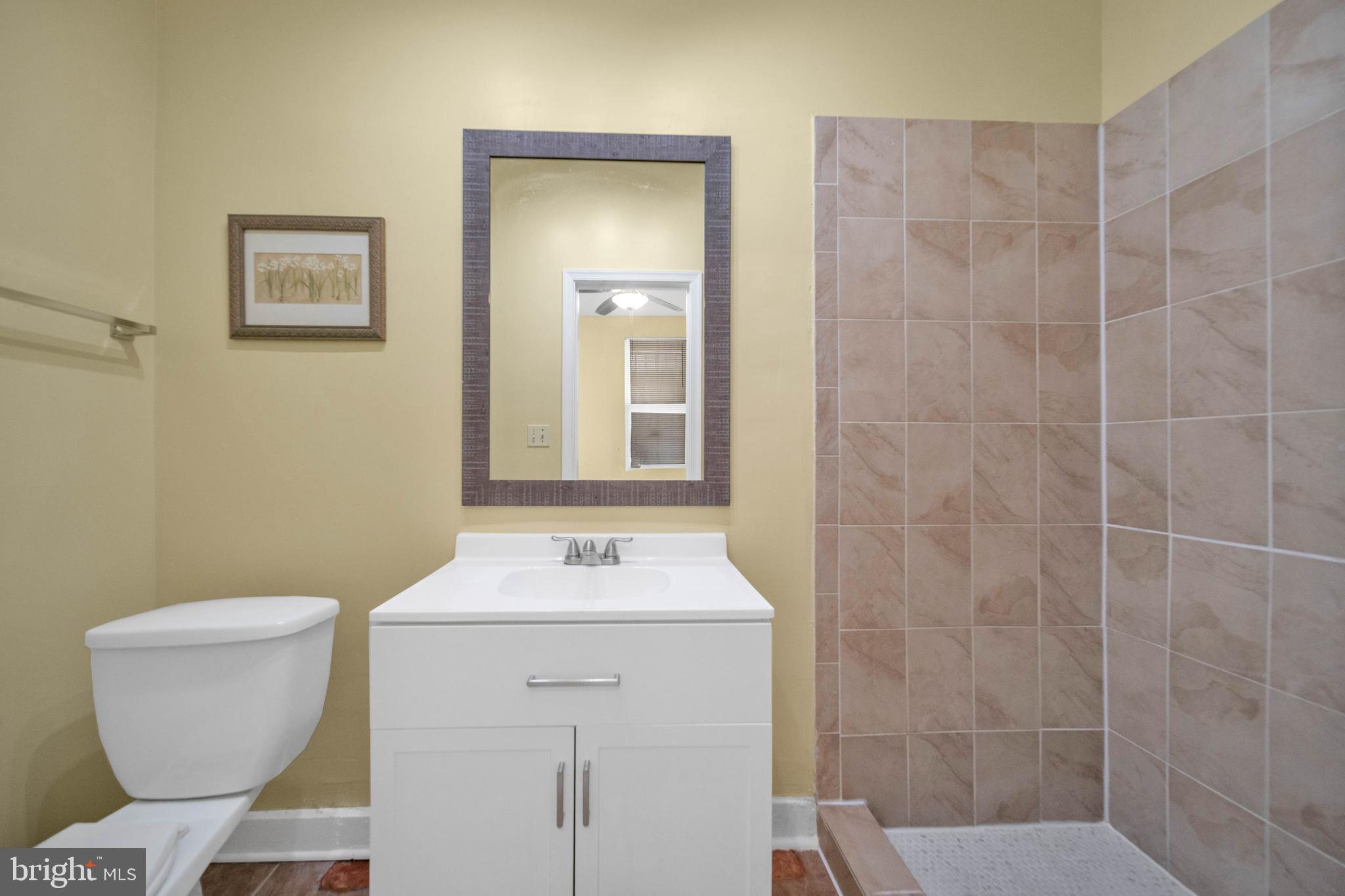 2712 Sherman Avenue Northwest Washington, DC 20001 - Photo 25 of 69 a bathroom with a sink a toilet and a mirror