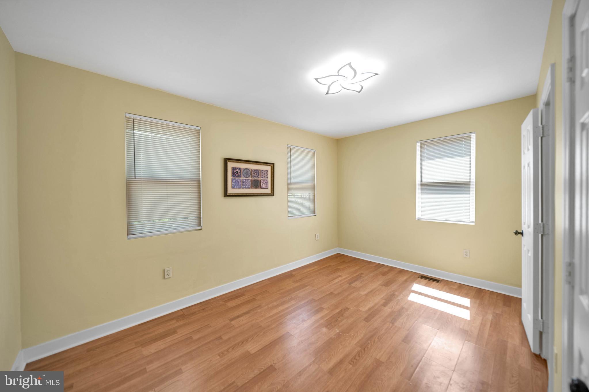 2712 Sherman Avenue Northwest Washington, DC 20001 - Photo 46 of 69 a view of an empty room with wooden floor and a window