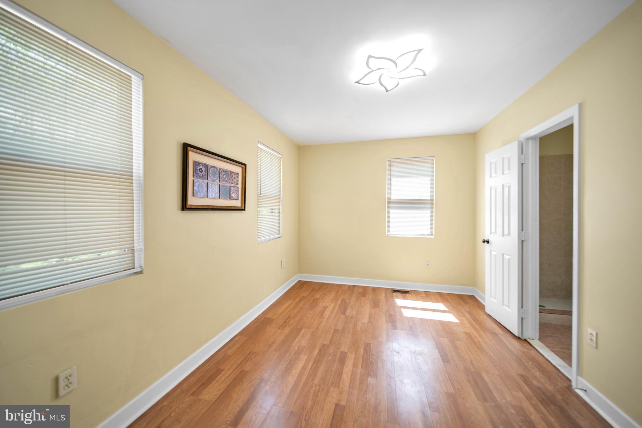 2712 Sherman Avenue Northwest Washington, DC 20001 - Photo 52 of 69 a view of empty room with wooden floor and fan